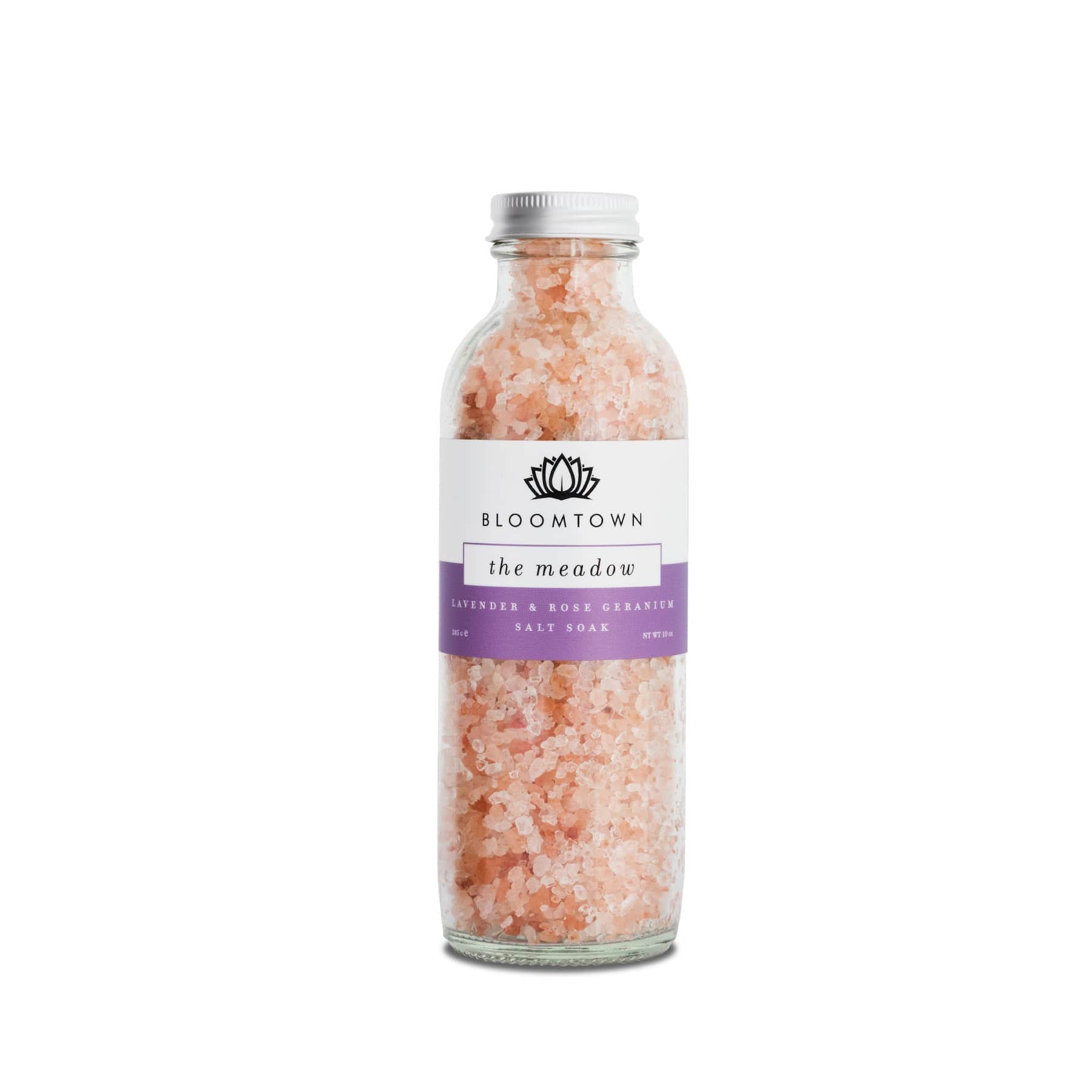 Bloomtown The Meadow lavender and rose geranium salt soak in transparent glass bottle with pink Himalayan bath salts isolated on white background
