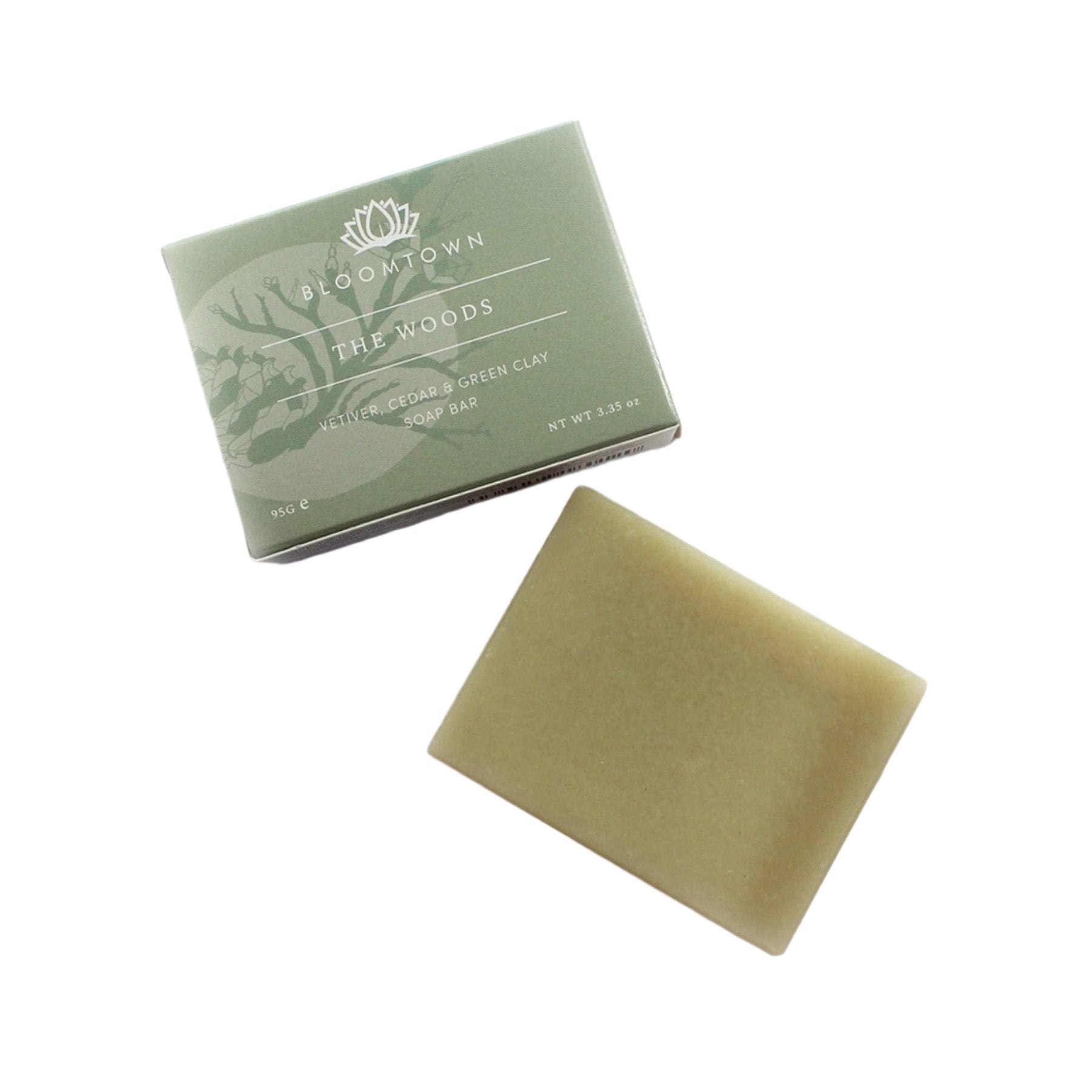 Bloomtown The Woods vetiver, cedar and green clay soap bar next to its packaging on white background