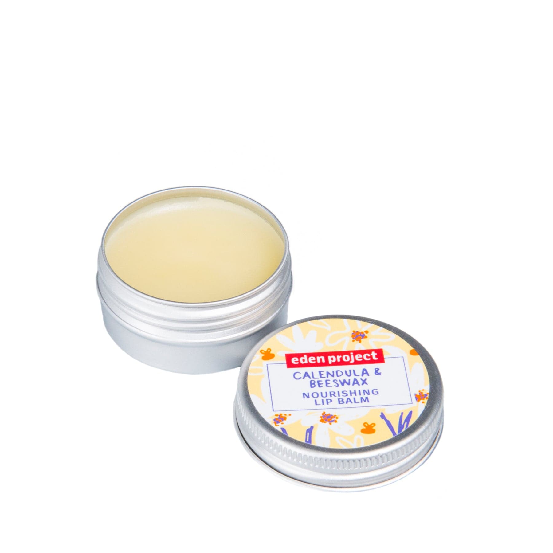 Eden Project calendula and beeswax nourishing lip balm in open tin container, organic skincare product on white background.