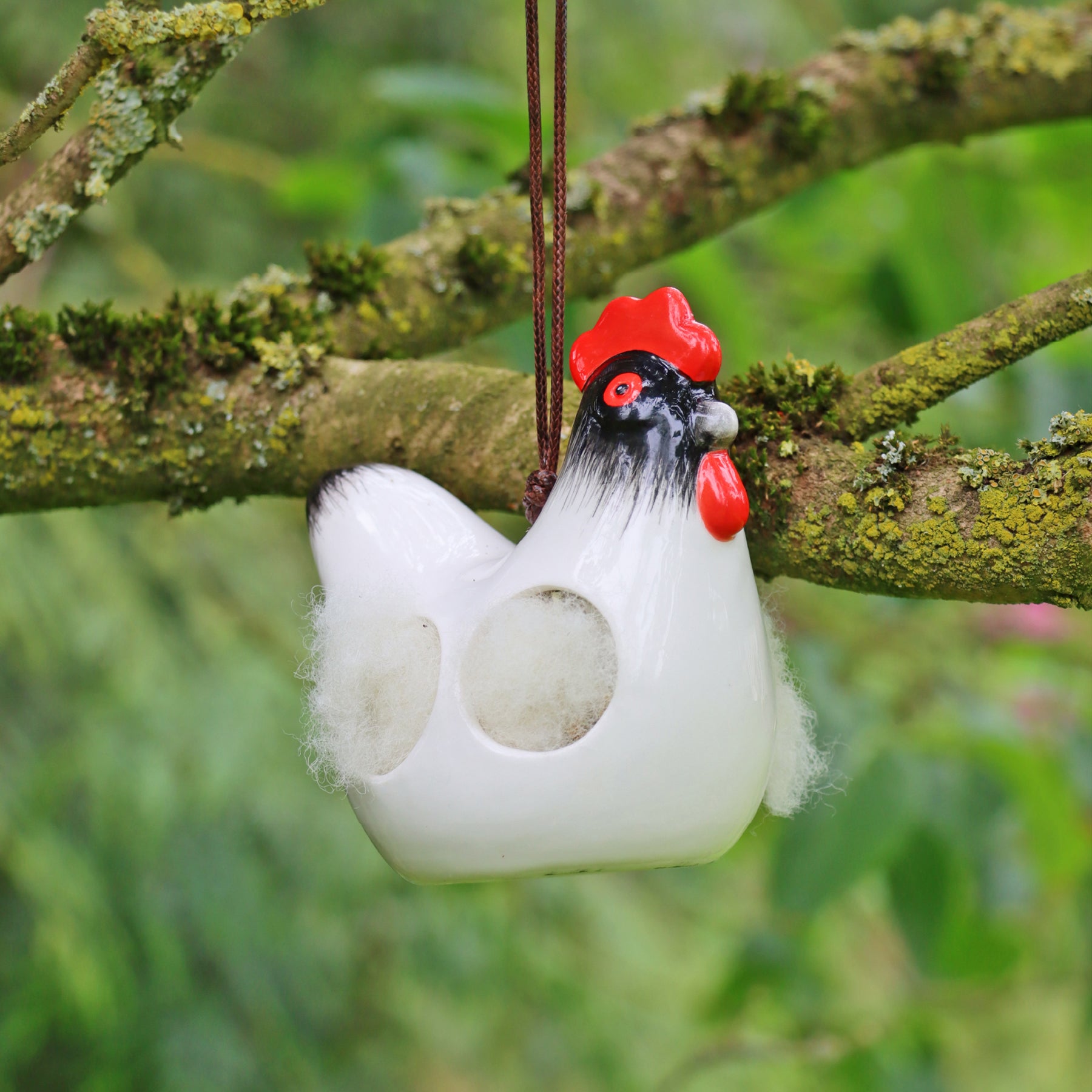'Cluckie' hanging ceramic hen with nesting wool