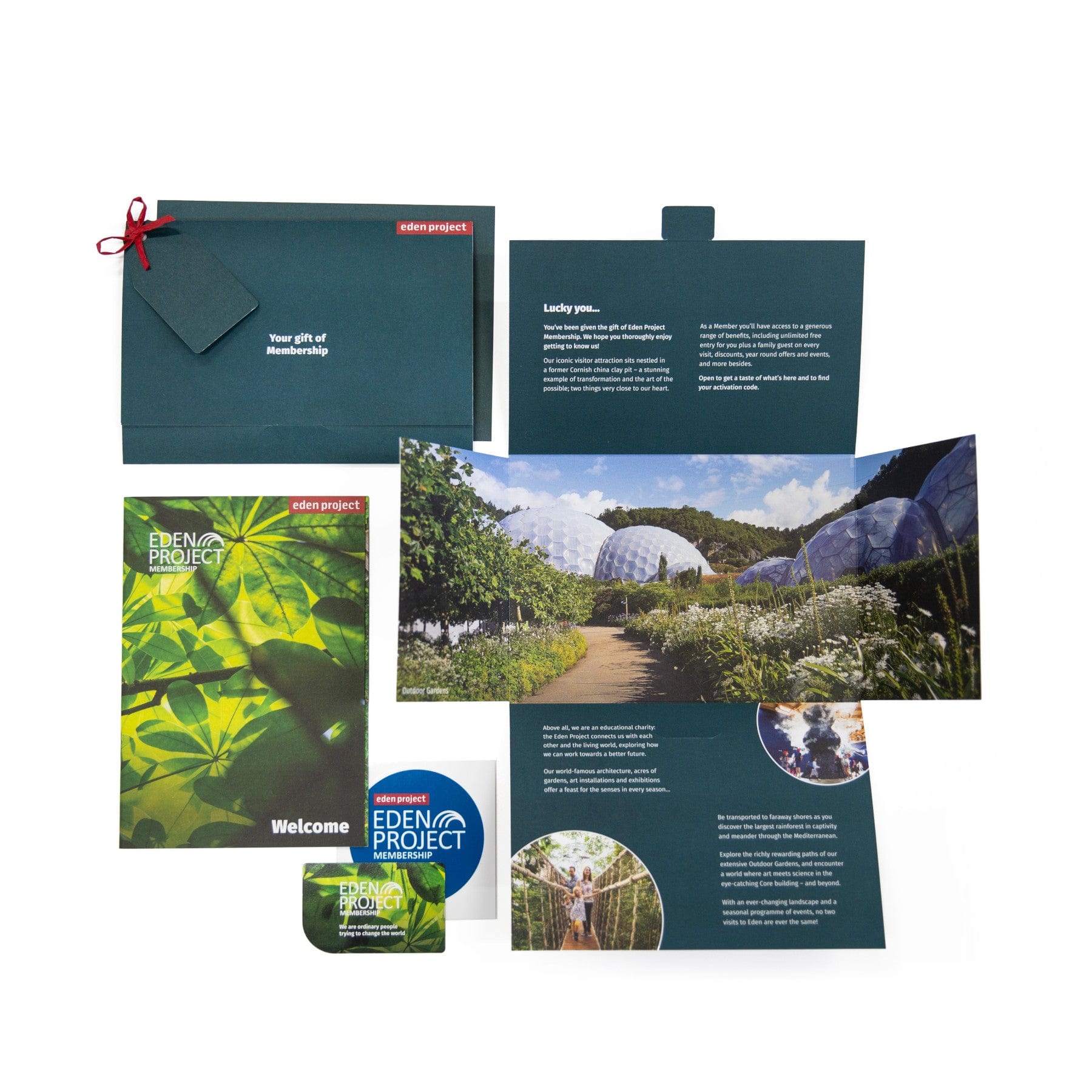 Eden Project membership pack with green brochure, welcome leaflet, membership card, and envelope with red seal displayed on white background.