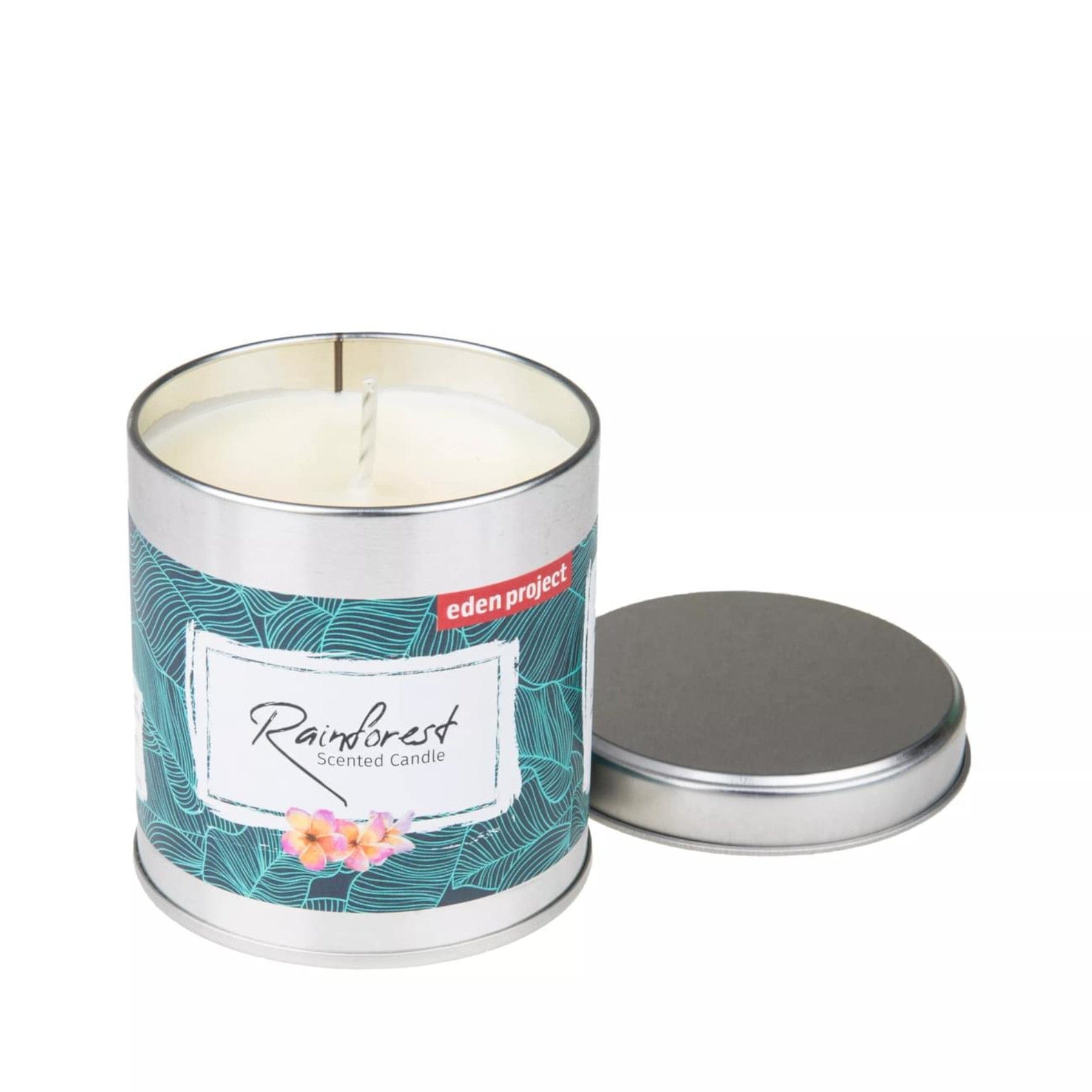 Eden Project Rainforest scented candle in a tin with a decorative tropical leaf pattern and detached lid, on a white background