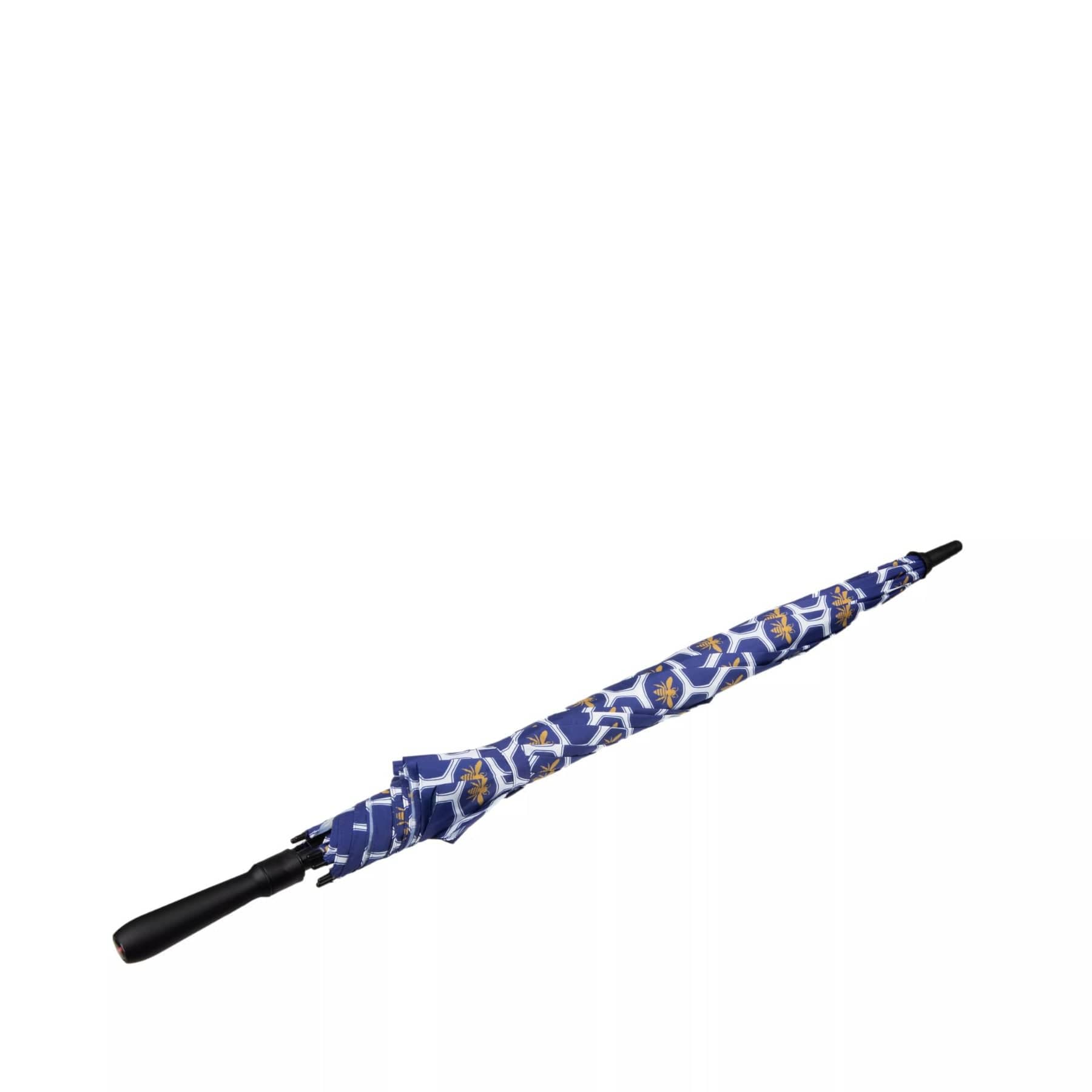 Patterned blue and white floral retractable umbrella with black handle and tip isolated on white background