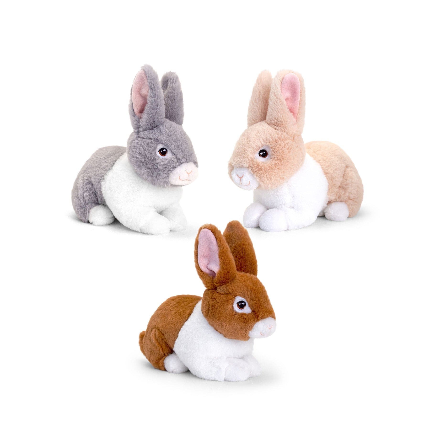 Three plush toy rabbits in different colors isolated on a white background