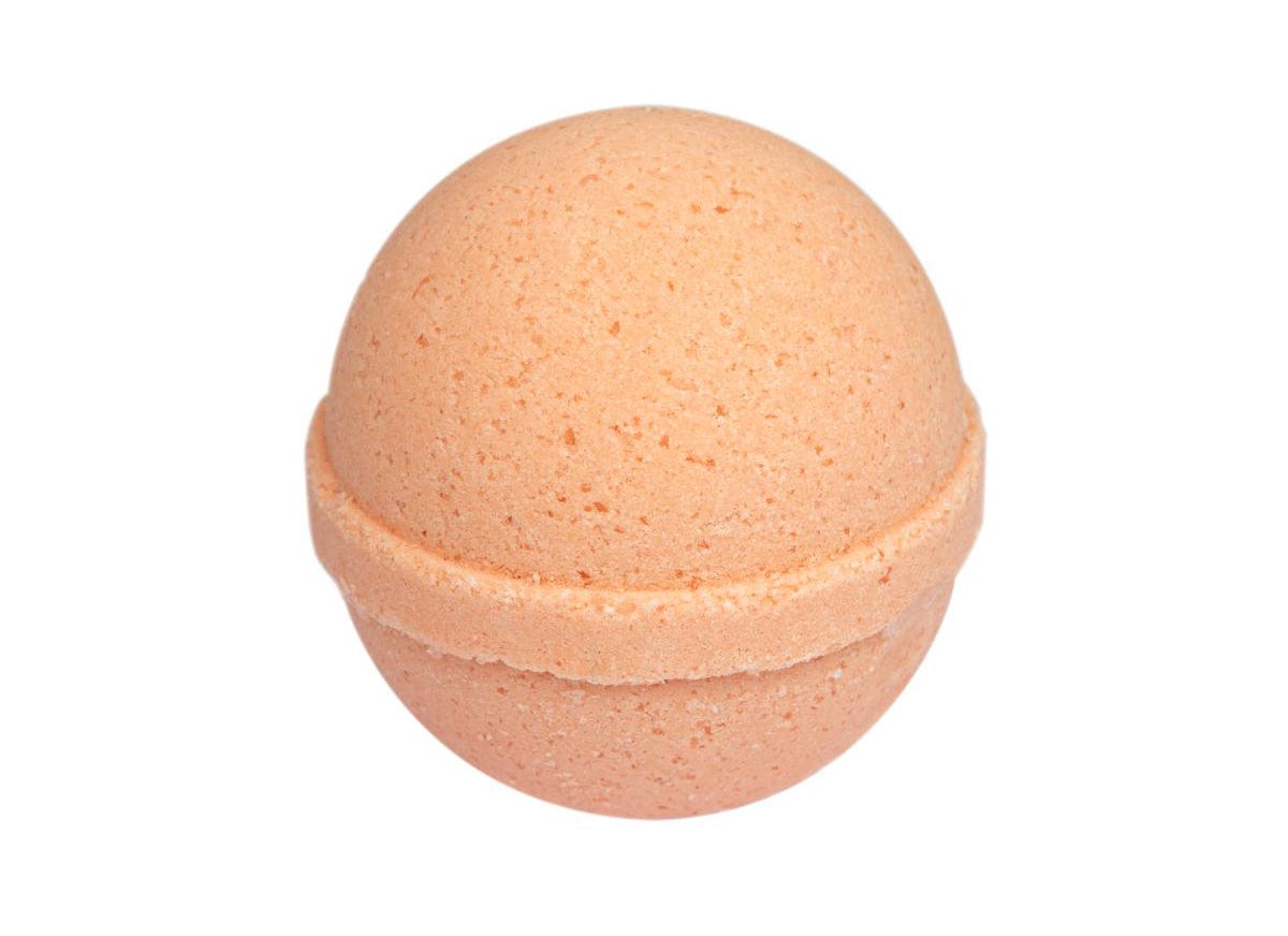Orange bath bomb isolated on white background, round fizzy bath bomb, spa aroma therapy, organic body care, skincare accessory, relaxation product, homemade cosmetics, wellness and self-care concept