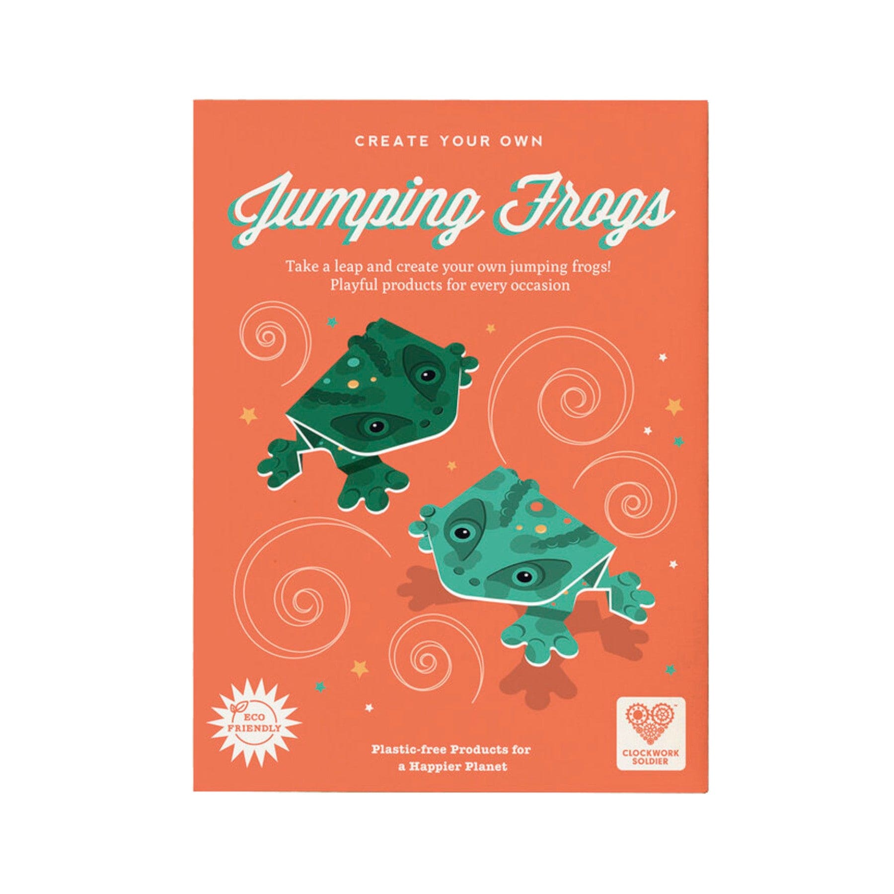 Eco-friendly Jumping Frogs craft kit packaging with playful green frogs illustration, 'Create Your Own' slogan, and plastic-free commitment badge.