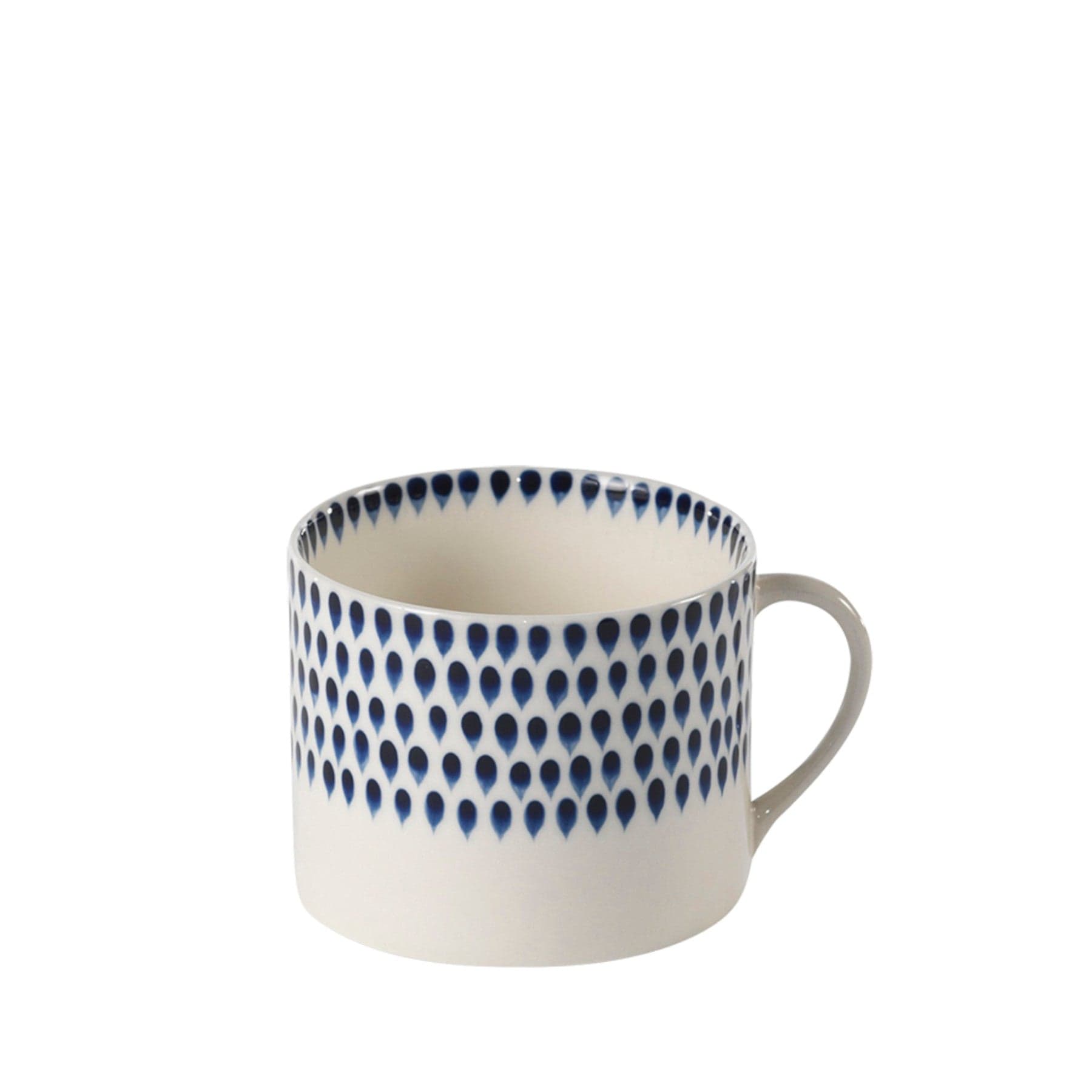 Blue and white ceramic mug with teardrop pattern isolated on a white background