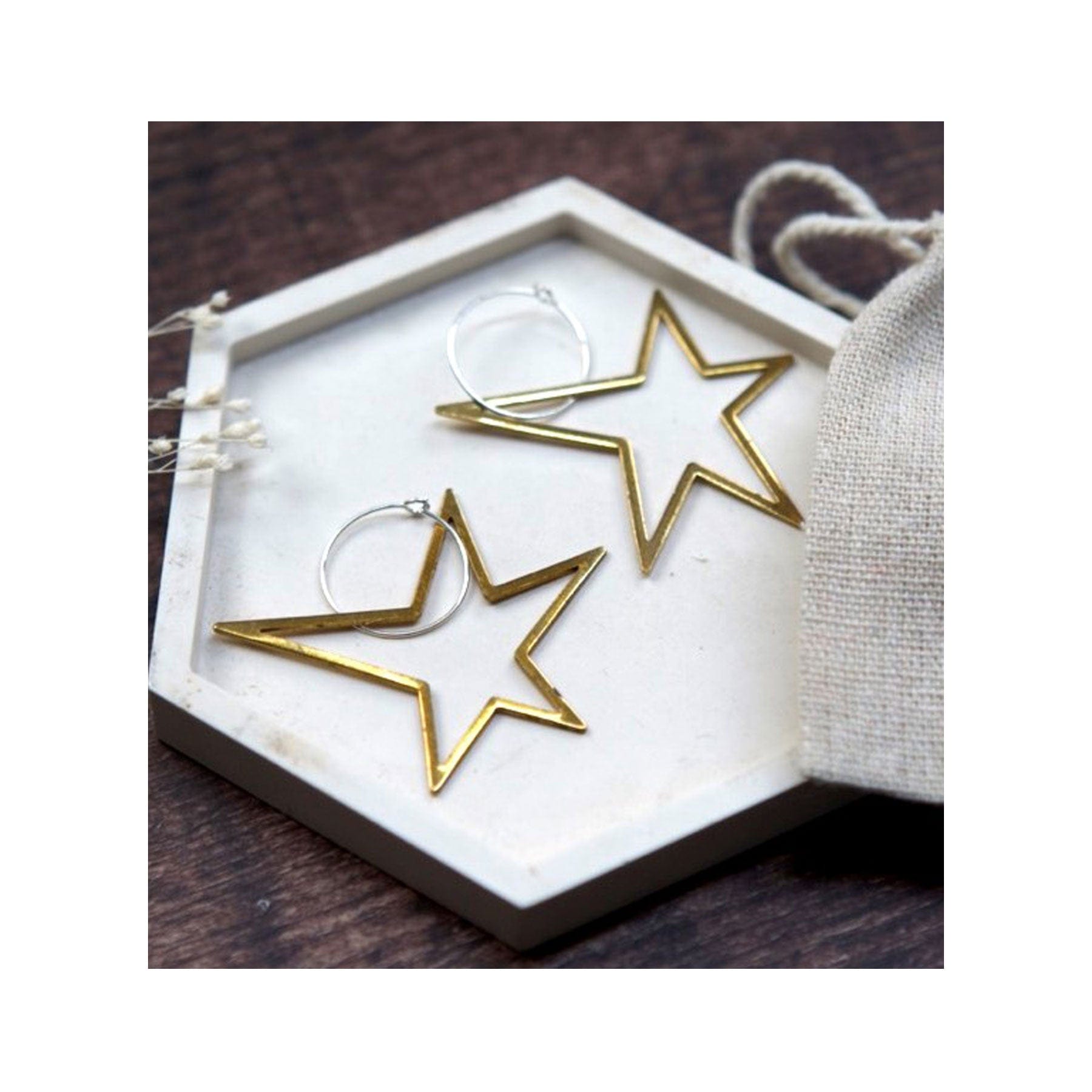 Large brass earrings open star