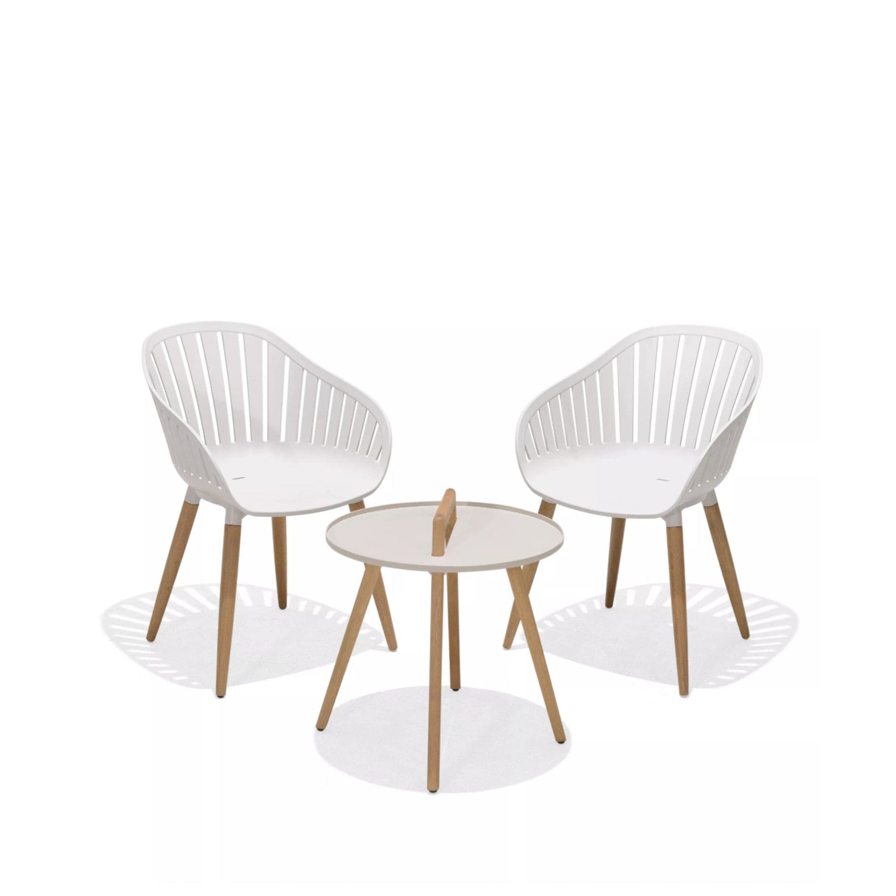 Two modern white dining chairs with wooden legs and a small round white and wooden coffee table on a white background