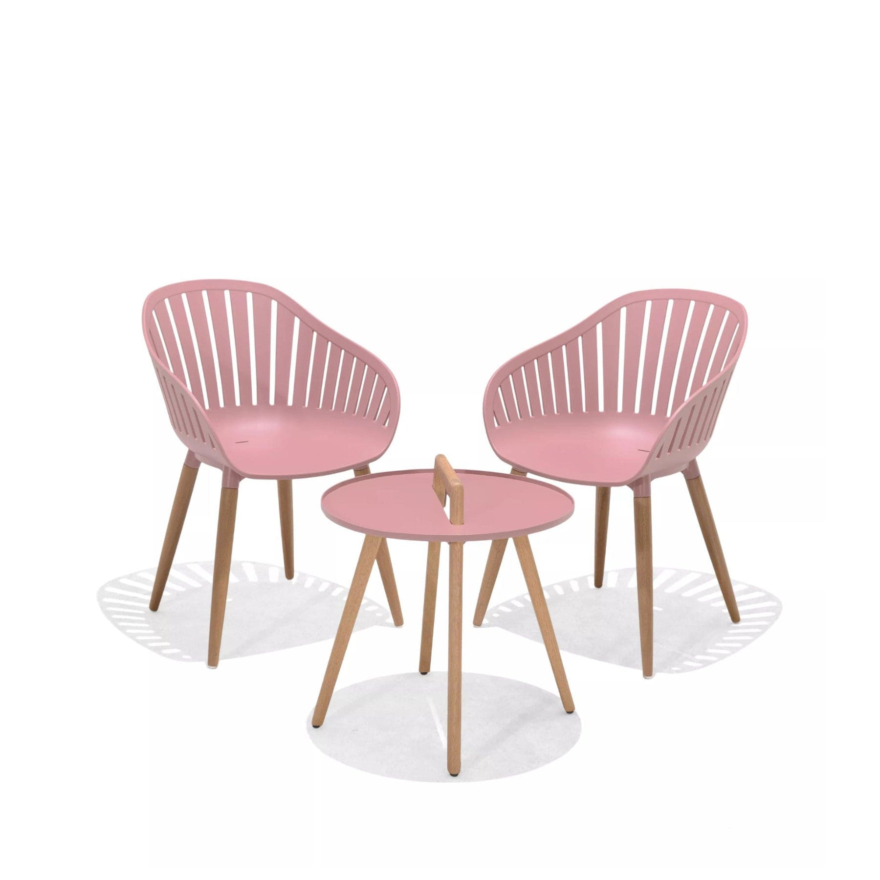 Two pink modern chairs with wooden legs and a matching round table on a white background