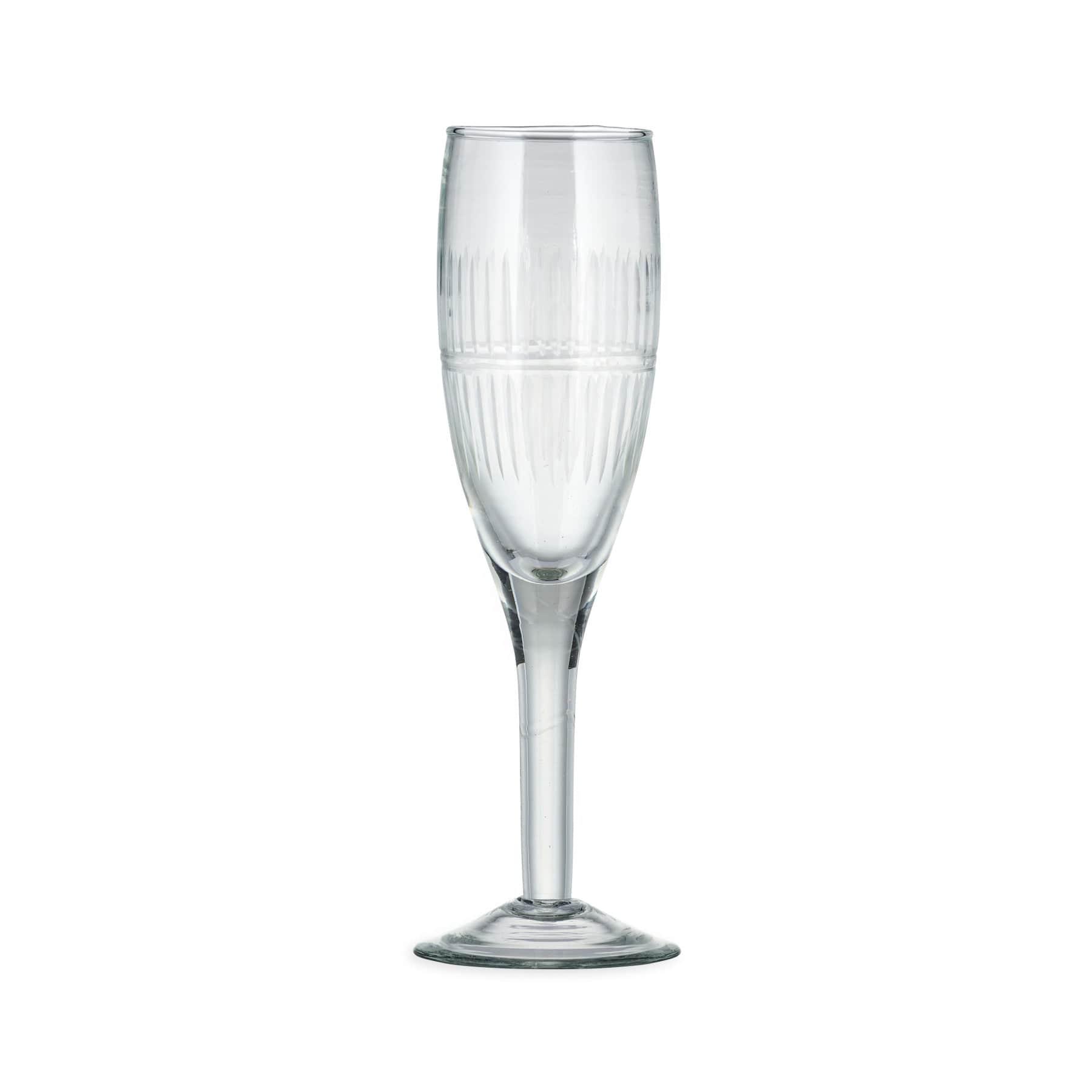 Empty champagne flute glass with ribbed detailing on white background