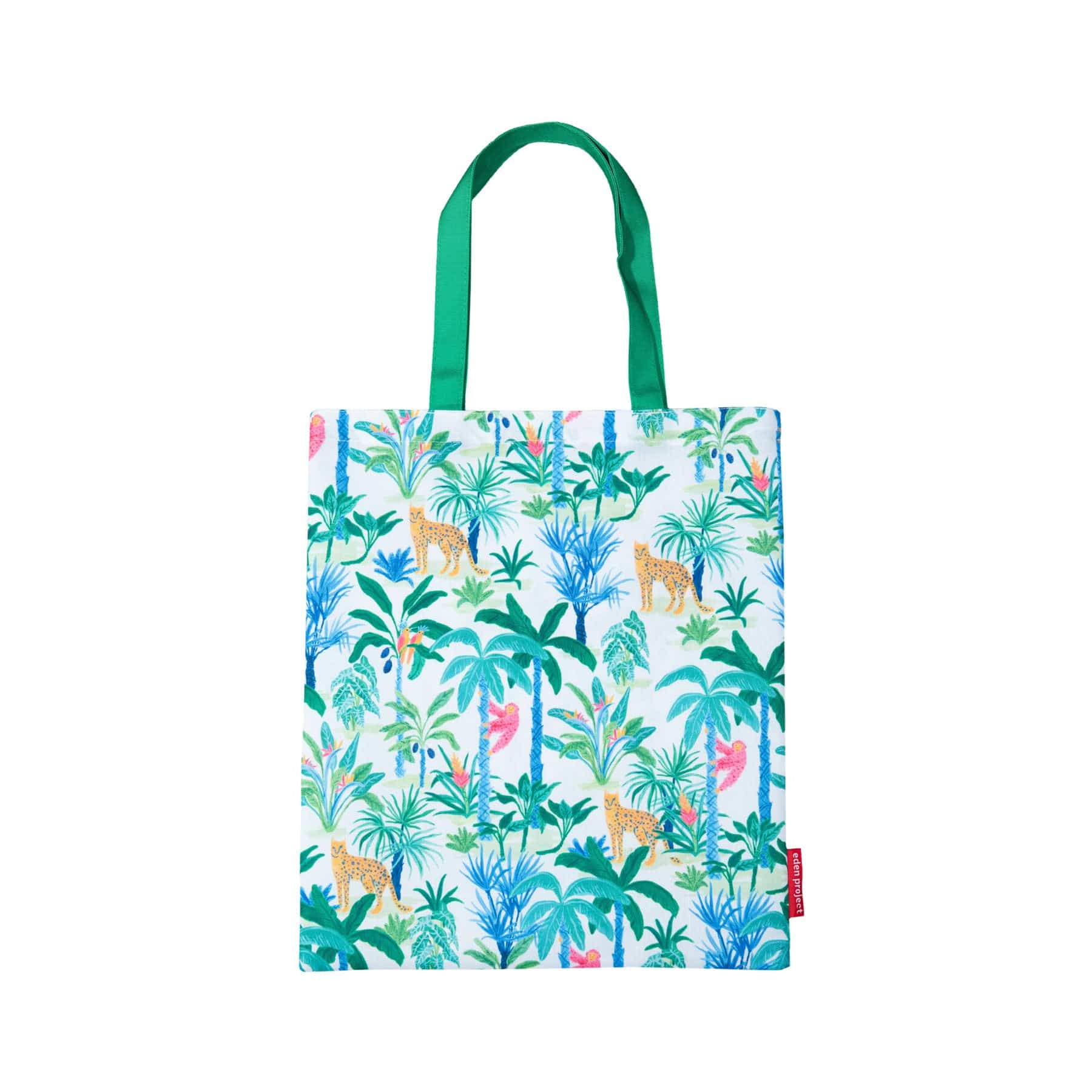 Colorful tropical print tote bag with palm trees, leopards, and foliage design against a white background with green handles and a visible brand tag.