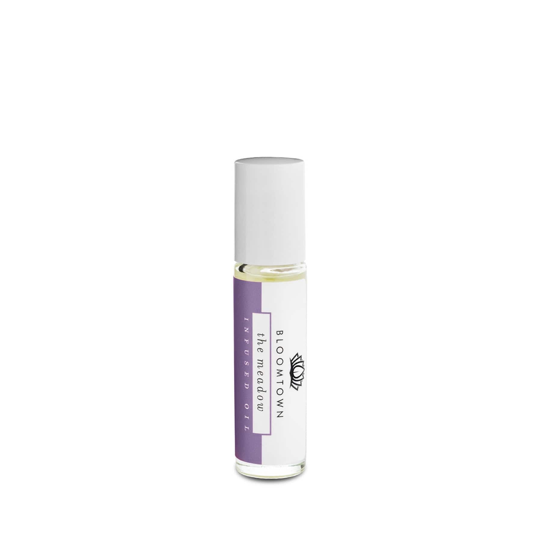 Essential oil roll-on bottle with white label and purple branding, isolated on white background.