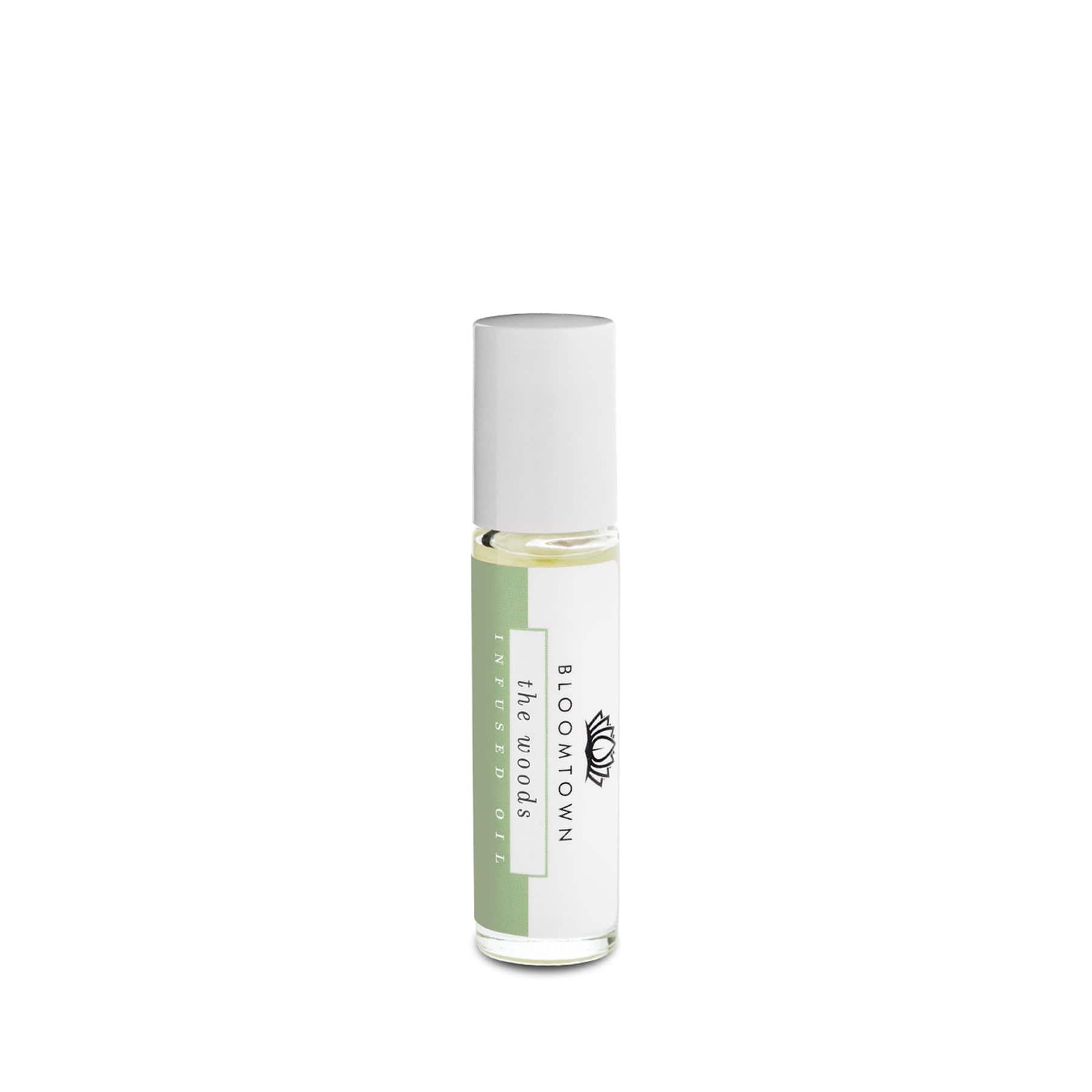Rollerball perfume oil bottle by Bloomtown with white cap and green label on a white background.