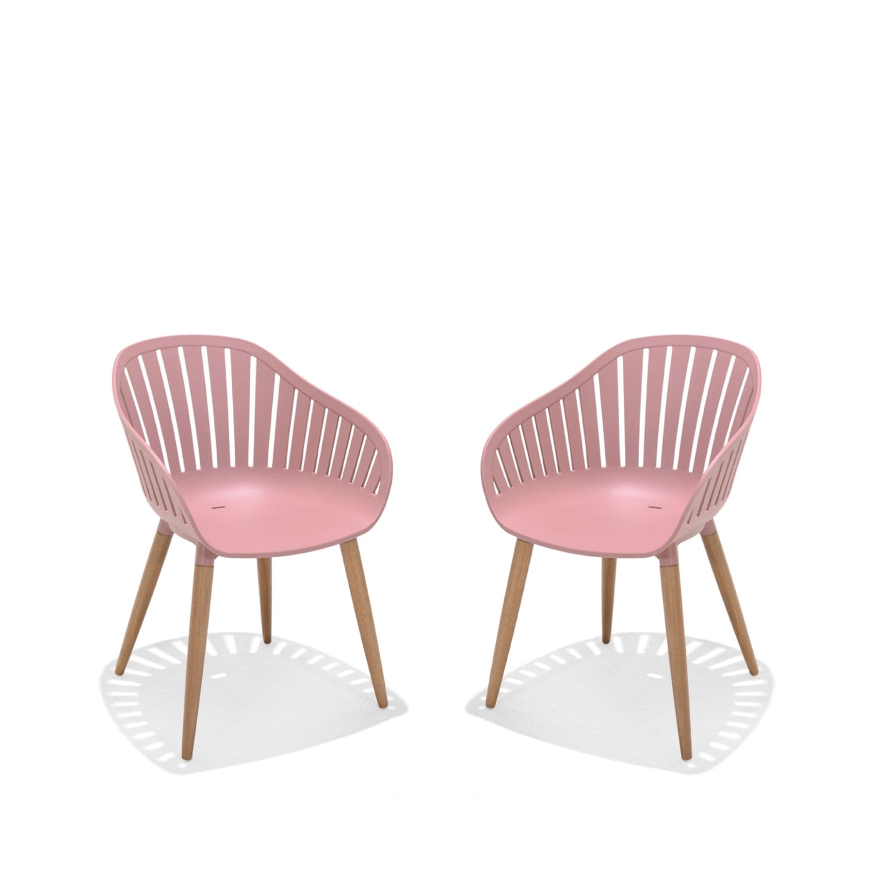 Two modern pink dining chairs with wooden legs on a white background